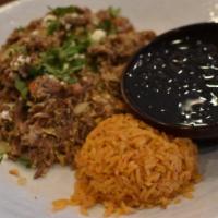 Machaca Con Huevos · Two eggs scrambled with shredded beef, tomatoes and onions then topped with queso cotija and...