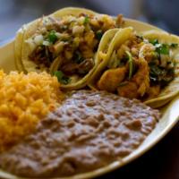 Taco Plate · 2 Tacos served with rice and beans.  Tacos are topped with onions, cilantro, and salsa. Your...