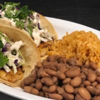 Baja Fish Taco Plate · 2 Grilled Fish Tacos topped with cabbage, cilantro, and a creamy chipotle sauce.Served with ...
