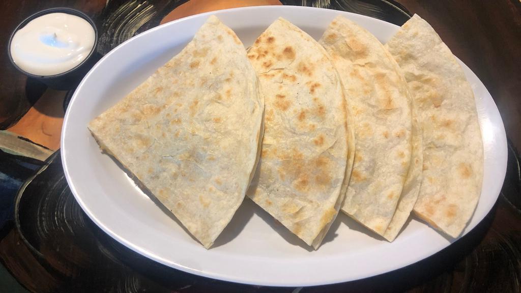 Quesadilla with Meat & Cheese · Large quesadilla filled with cheese and your choice of meat .  With two ounces sour cream on the side