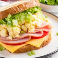 Sunnies · A delicious breakfast sandwich with scrambled egg, cheddar cheese, avocado, cucumber, and to...