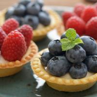 Baked Berries and Almond · A buttery short dough tart shell filled with frangipane, assorted berries, baked until golde...