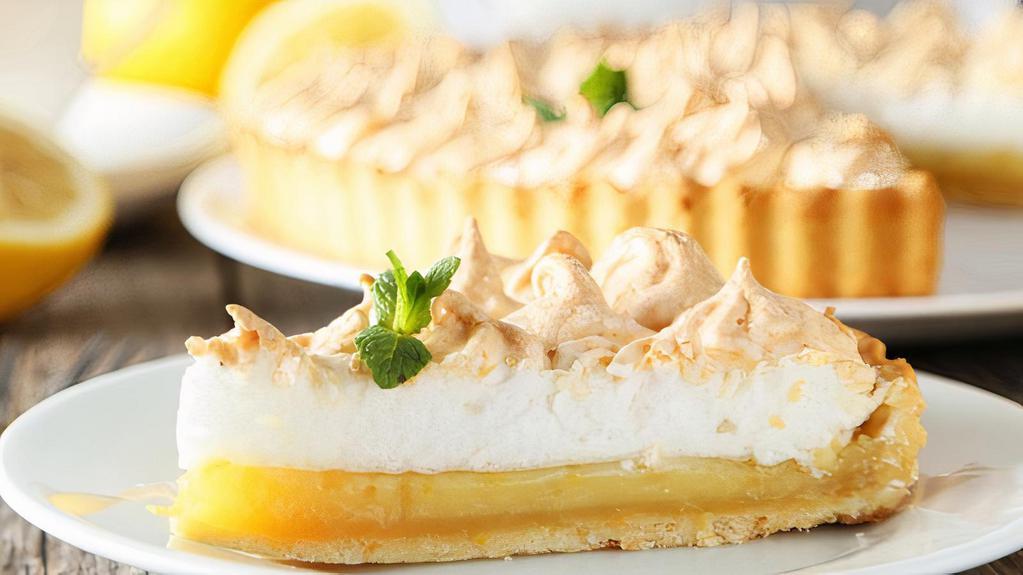 Lemon with Meringue · A buttery short dough tart shell filled with lemon curd, topped with a generous swirl of baked meringue and finished with a delicate dusting of confectionery sugar.