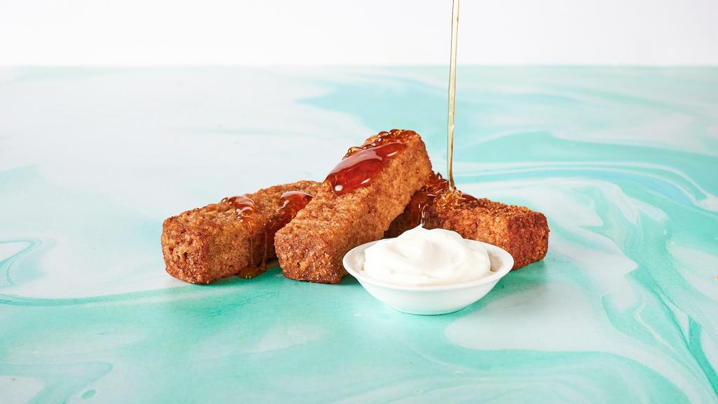 French Toast Sticks · Baked french toast sticks with whipped cream and warm maple syrup for dipping