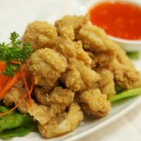 8. Pla Mauk Tod · Crispy fried calamari served with house sweet and sour sauce.