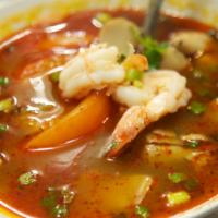 33. Tom Yum Koong Soup · Hot and sour prawn soup with tomatoes, lemongrass, mushrooms, onions, and galangal.