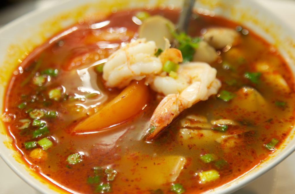 33. Tom Yum Koong Soup · Hot and sour prawn soup with tomatoes, lemongrass, mushrooms, onions, and galangal.