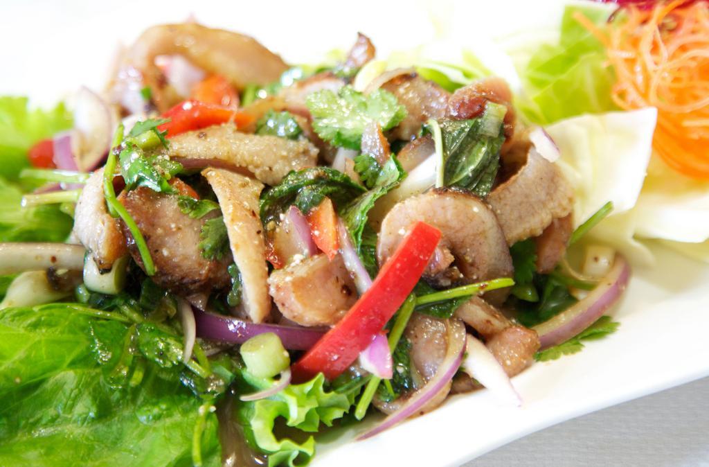 29. Yum Kor Moo Yang Salad · Grilled pork shoulder salad with spicy lime dressing, onions, mint leaves, and rice powder.
