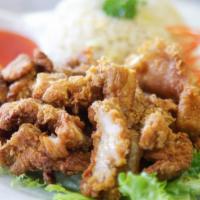 102. Crispy Pork with Fried Rice · Fried rice with pork, served with sweet and sour sauce.