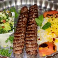 18. Beef Kabob (Koobideh) · Two skewers of ground beef tastefully seasoned with onions. Served with grilled tomato.