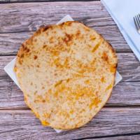 Cheese Naan · Baked in traditional clay oven.