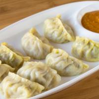 Vegetable Momo (Vegan) · Steamed dumplings filled with cabbage, 
carrot, cauliflower, broccoli, chives & spices.