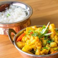 Alu Cauli · Organic cauliflower and potatoes cooked deliciously with special herbs and spices. Served wi...