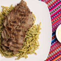 Tallarines Verdes Con Bistec · Spaghetti sautéed in pesto sauce with steak.