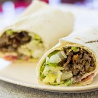 23. Lamb Shawarma Wrap · Seasoned, slowly roasted lamb, shaved thinly, and served with lettuce, tomatoes, parsley, on...