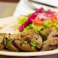 27. Lamb Shish Kabob Wrap · Tender marinated lamb on a skewer char-broiled then pulled onto lavash bread with lettuce, t...