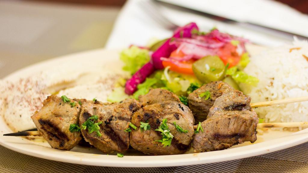 27. Lamb Shish Kabob Wrap · Tender marinated lamb on a skewer char-broiled then pulled onto lavash bread with lettuce, tomatoes, and onions.