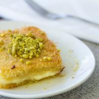 18. Kanafeh · Sweet arabic cheese wrapped in filo dough with syrup and crushed pistachio nuts.
