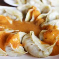 Chicken Momo's · Classic Nepali momo's made with chef's special sauce.