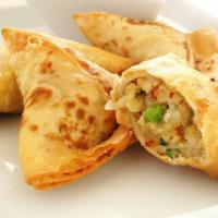 Crispy Vegetable Samosa · Vegetarian delight fried and filled with cooked potatoes and green peas.