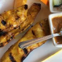 Satay Chicken (5) · Grilled marinated chicken on skewers, served with peanut sauce and cucumber salad.
