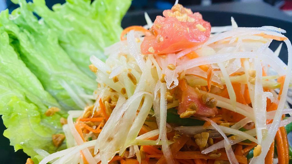 Papaya Salad · Green papaya, carrots, green bean, tomato and crushed peanut in lime juice dressing. Add grilled prawn for an additional charge. Available in Laotian style.