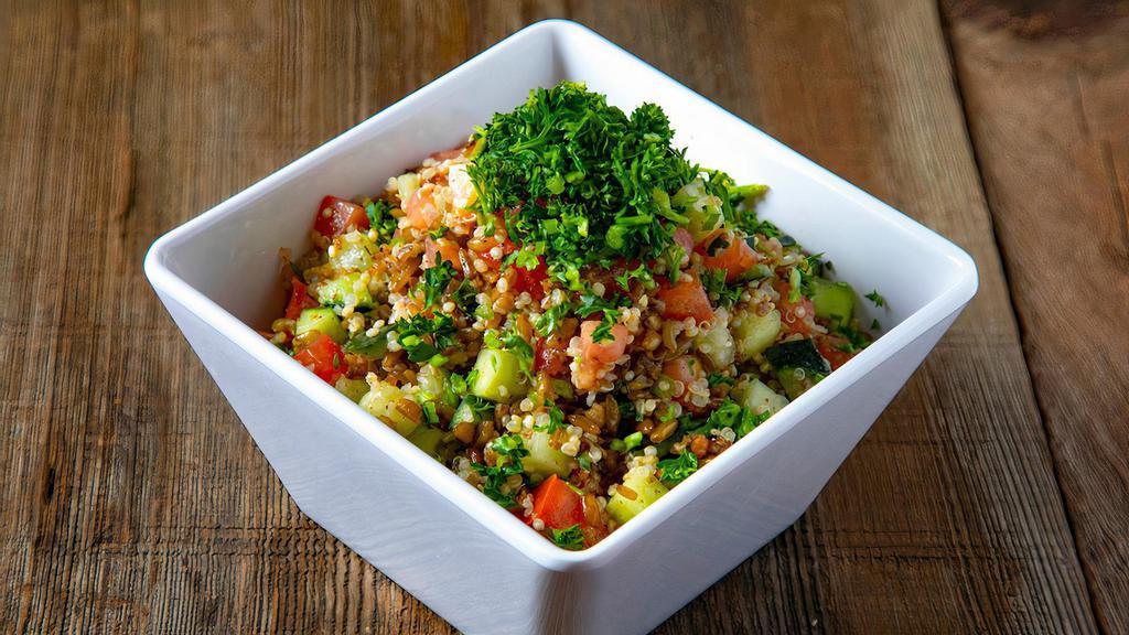 Quinoa Salad · Quinoa, freekeh, tomato, cucumber, and lemon olive oil dressing on the side.