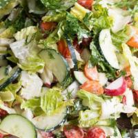 Green Salad · Creamy avocado, cucumbers, tomatoes, and onions over a bed of fresh greens with a side of ho...