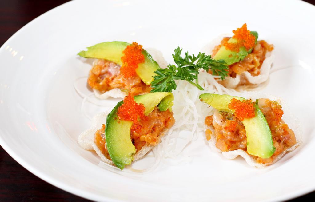 Hamachi Tartare · Yellowtail with onions and avocado, on shrimp chips (four pieces).