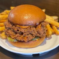 Spicy Fried Chicken Sandwich · Two perfectly fried chicken breast pieces stacked on a freshly toasted brioche bun. Served w...