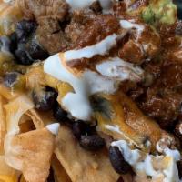 Double Decker Nachos · Two layers of house made tortilla chips and 4 types of cheese topped with green and red sals...