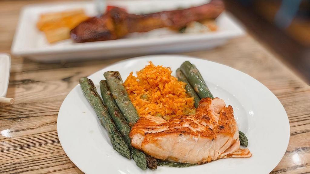 Grilled Salmon · Served with cilantro chimichurri, Yucatan rice, and grilled seasonal vegetables.