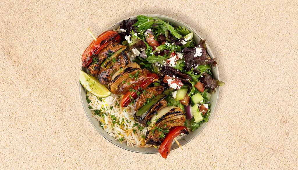 Lamb Kabob Plate · Served with seasoned rice and a salad of mixed greens, tomatoes, and cucumber.
