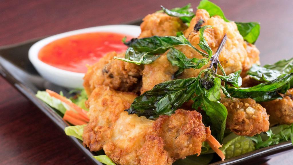 4. Fried Chicken Wing · Fried chicken wing topped with crispy Thai basil and sweet chili sauce.