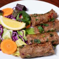 Lamb Seekh Kabab (4 Pieces) · Minced lamb, onions, chili, herbs, and spices skewered and baked in tandoor.