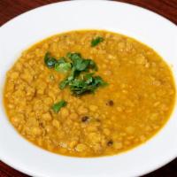 Daal · Yellow lentils cooked in curry sauce, herbs and spices.