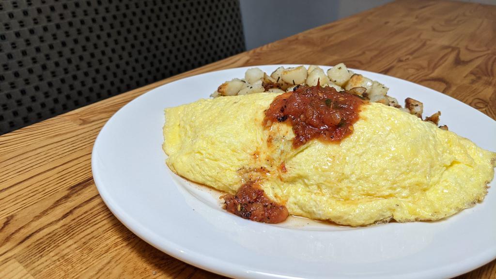 Mazatlan Omelette · Soy bean chorizo or chicken apple sausage, black bean chili, jack, and cheddar cheese with salsa fresca. Made with three eggs and served with home potatoes and toast.