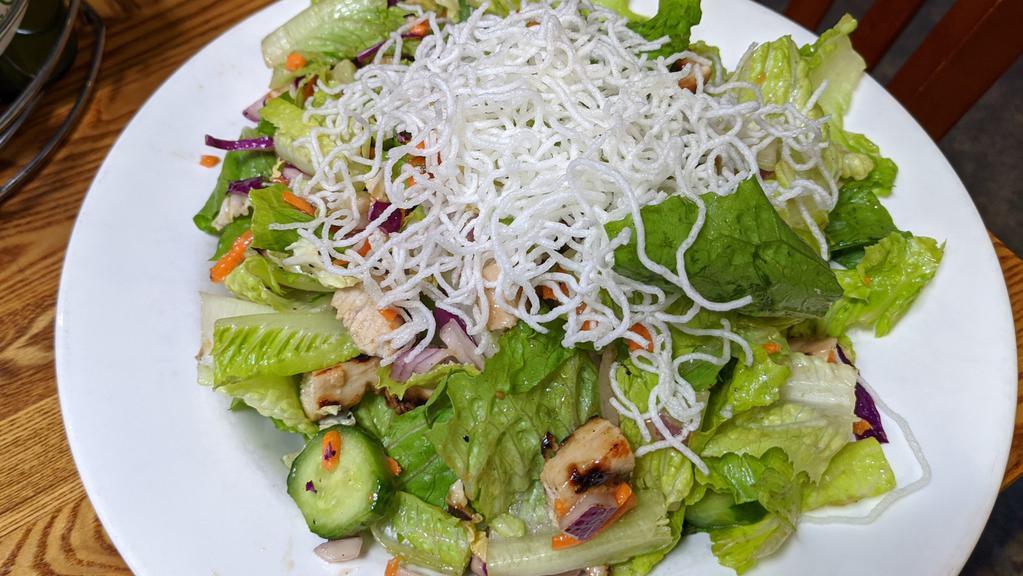 Asian Chicken Salad · Rice noodles, cabbage, red onions, cucumbers, shredded carrots, cilantro, and peanuts tossed with Asian dressing.