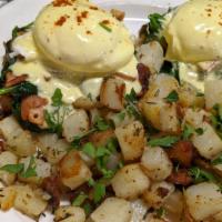 Costa Del Sol · Sautéed ham, spinach, and onions with poached eggs on an English muffin with hollandaise sau...