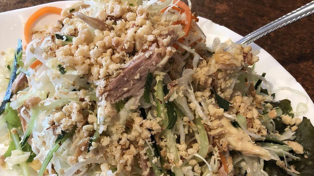 2. Chicken Salad with Cabbage · *Contains Peanuts.* Shredded chicken, carrots, daikon, cucumber, onions, cilantro, fried shallots, & peanuts tossed with house made dressing