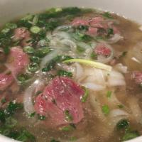 09. Rare Beef Noodle Soup (Filet Mignon) · Flat rice noodles served in beef broth topped w/ sliced rare filet mignon, onions, cilantro,...