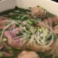 11. Rare Beef & Beef Ball Noodle Soup (Filet Mignon) · Beef ball & flat rice noodles served in beef broth topped w/ sliced rare filet mignon, onion...