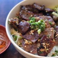 31. BBQ Pork with Vermicelli  · *Contains Peanuts.* Flame grilled BBQ pork topped w/ peanuts, scallion, lettuce & shredded c...