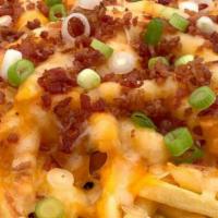 Fried Chicken Bacon Fries · Twice fried fries topped with fried chicken, bacon, melted cheese, and smothered in ranch.