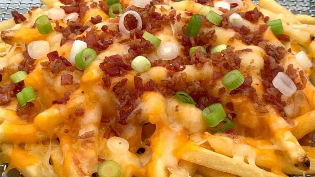 Fried Chicken Bacon Fries · Twice fried fries topped with fried chicken, bacon, melted cheese, and smothered in ranch.