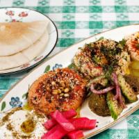 Mezze Sampler · Lebna, muhammara, baba ganoush, hummus, pickles, two falafels, amba.
