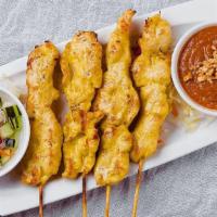 Chicken Satay · Chicken on skewers, marinated with fresh herbs and spices, served with peanut sauce and cucu...