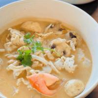 Tom Kha · Coconut soup with lemongrass, mushrooms, tomato, onions, cilantro, kafﬁr lime leaves, and a ...