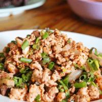 Larb · Ground meat, Roasted rice, green onion, red onion, mint and larb dressing