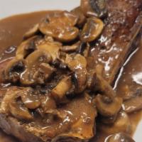 New York Steak · New York steak with a mushrooms demi glace sauce, served medium rare